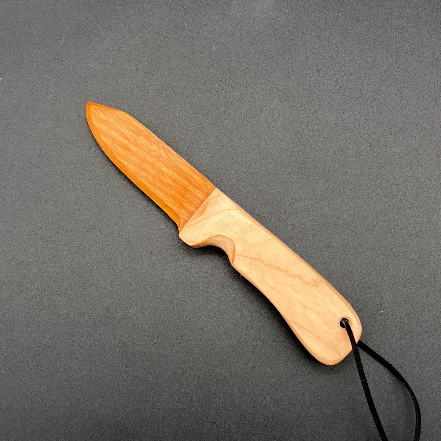 A wooden wax play knife with a blade made with canarywood, a yellow-orange wood
