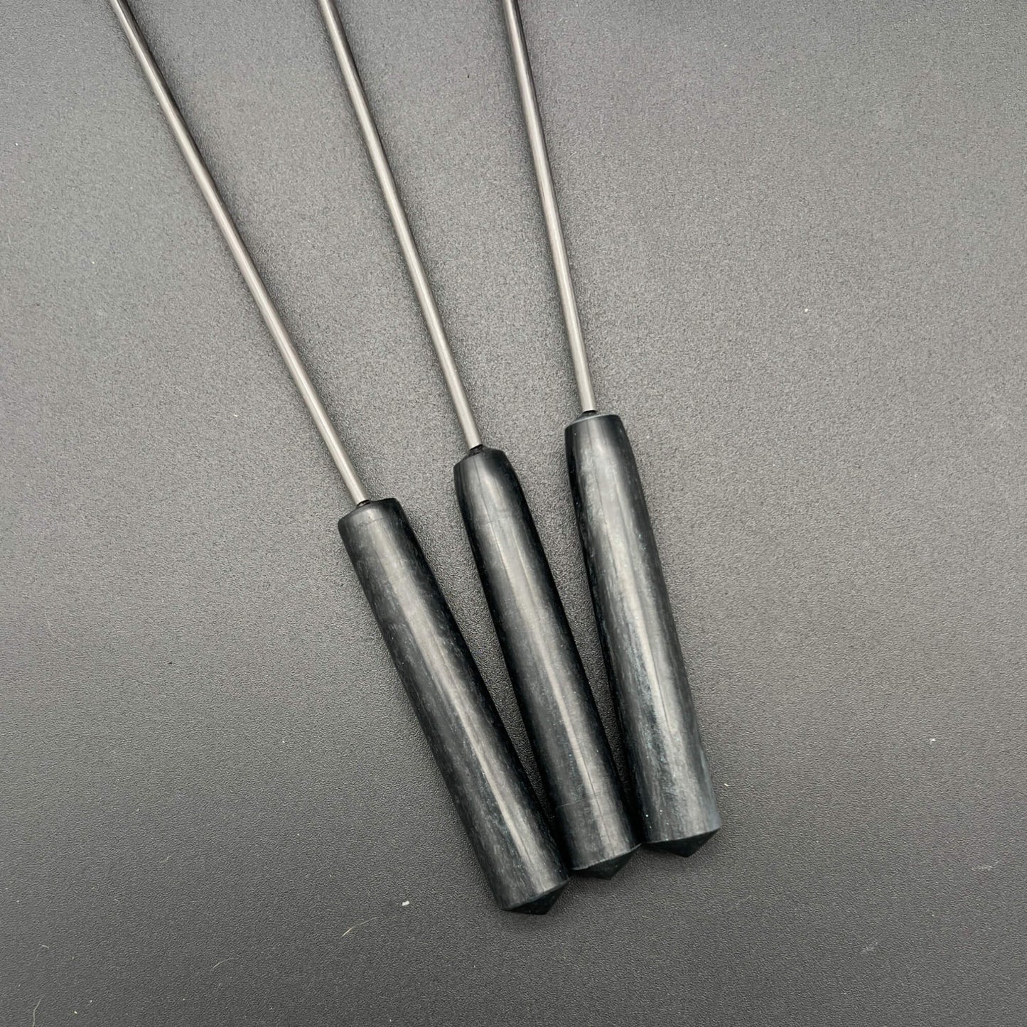 Three black resin handles for the Lips Diabolical Sticks , perfect for BDSM play.