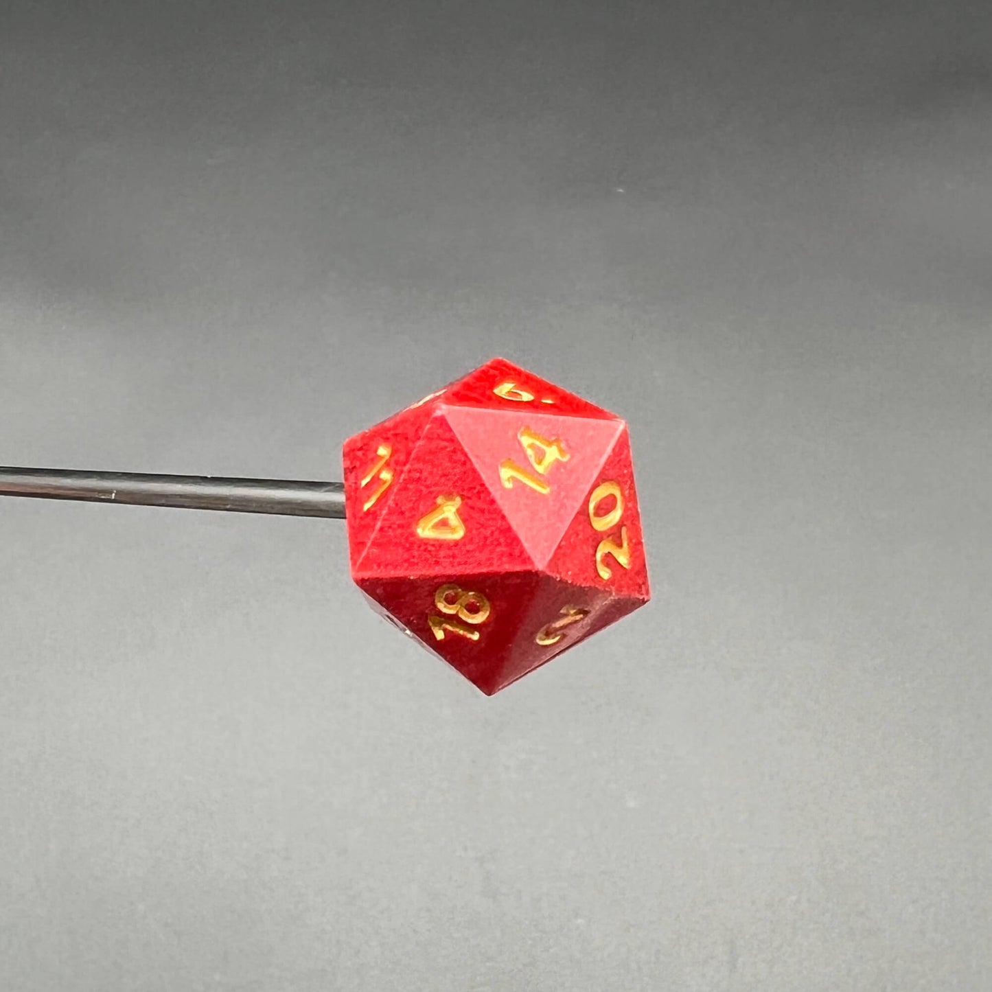 Red D20 Diabolical Sticks featuring gold numbering for TTRPG players and kinksters in action.