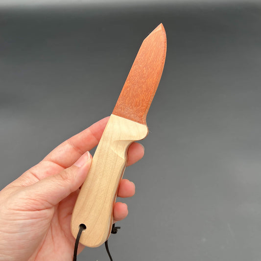 Hand holding a Wooden Wax Play Knife with a straight edge, crafted from exotic wood.