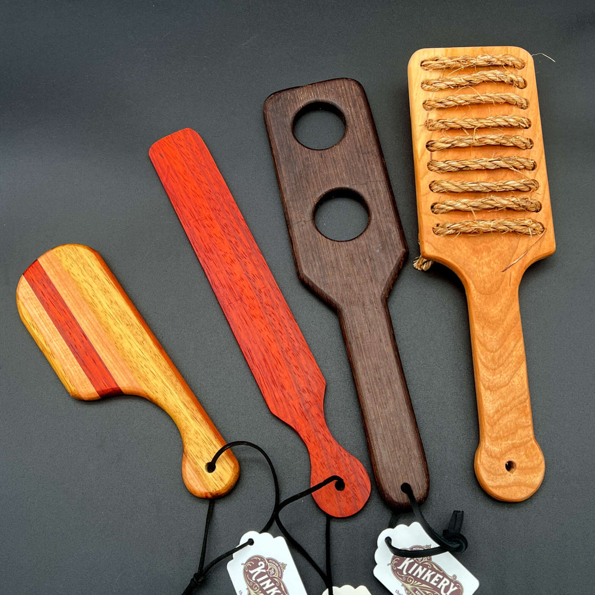 Not So Basic Paddles - a collection of unique wooden paddles in various styles and colors.
