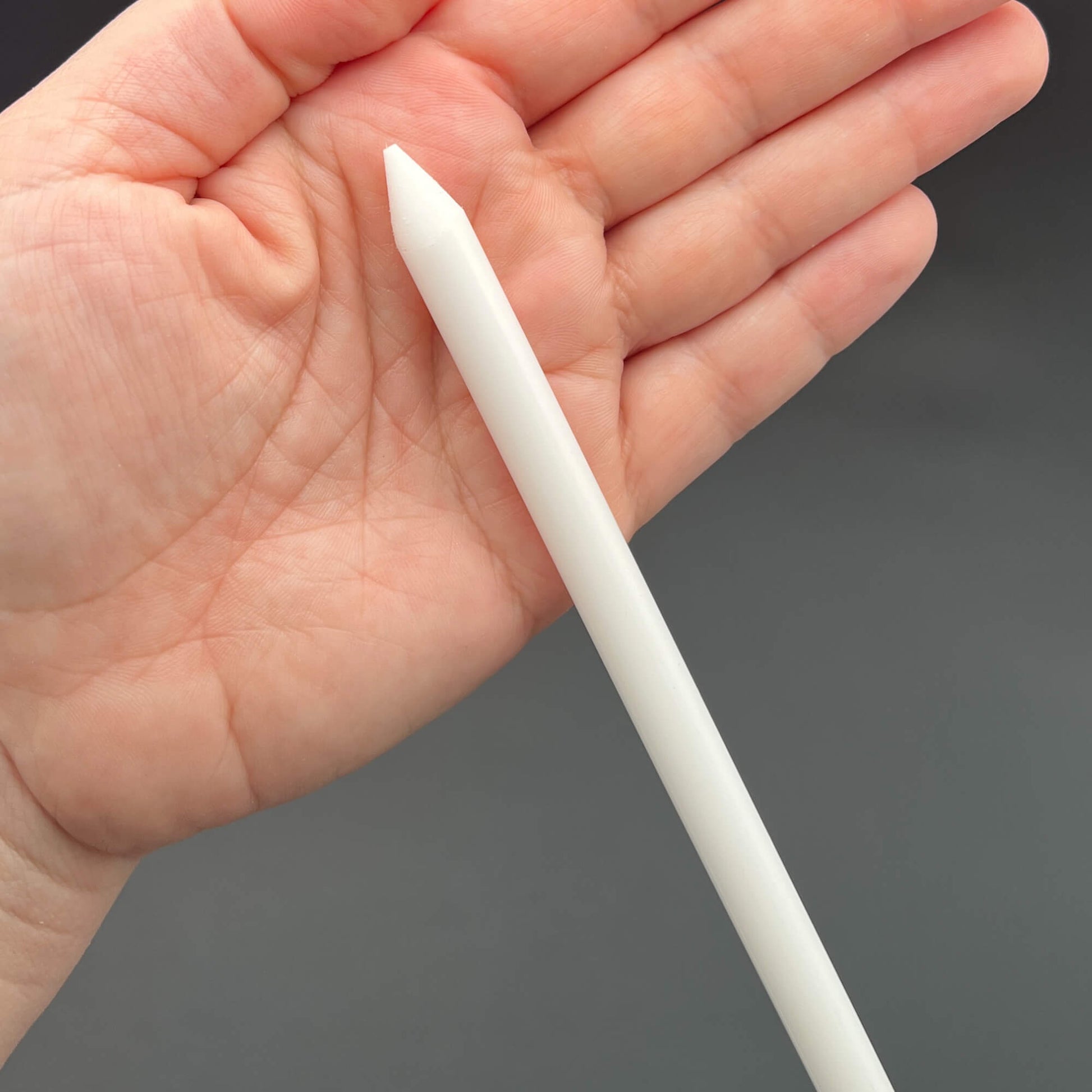 3/8 Inch Delrin Cane with Exotic Wood Handle held in a hand, showcasing its thickness and sturdy design.