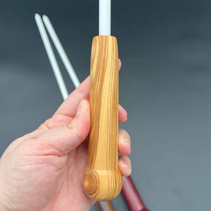 3/8 Inch Delrin Cane with Exotic Wood Handle being held in hand, showcasing unique handle design.