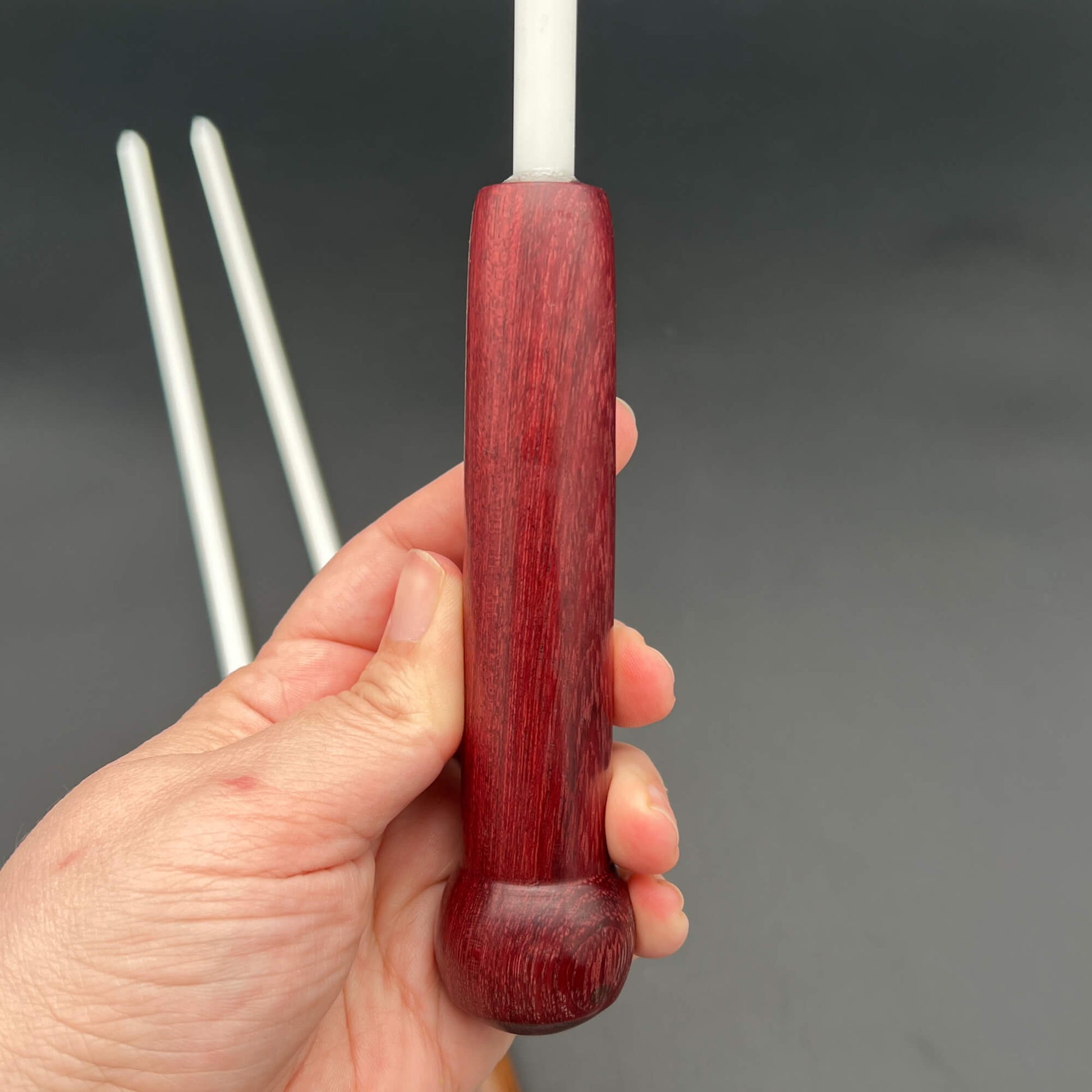 3/8 Inch Delrin Cane with Exotic Wood Handle held in hand, showcasing the ergonomic design and craftsmanship.