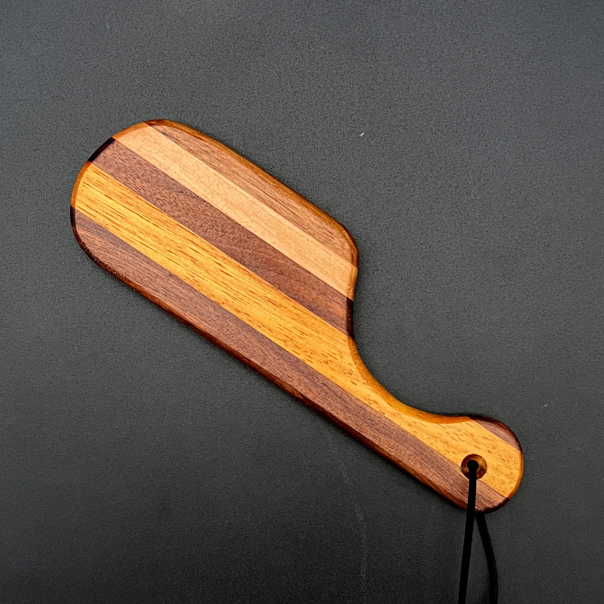 Small Pocket Paddle made from Black Walnut and Maple with a unique striped design.