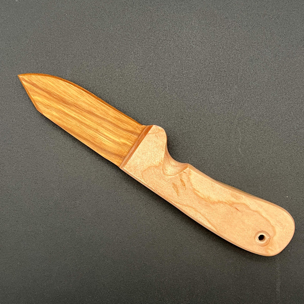 Wooden wax play knife with a blade made of Beli (a light-brown striped wood)