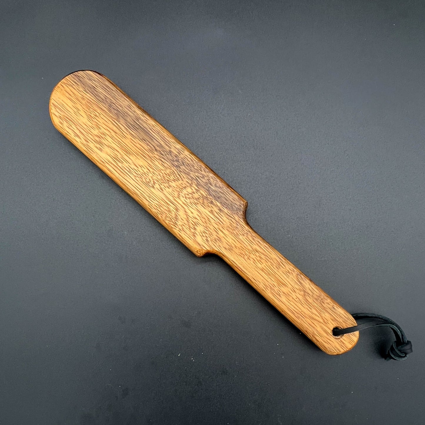 Wooden paddle Pounder measuring 12 inches long, finished with natural wax to showcase wood grain.