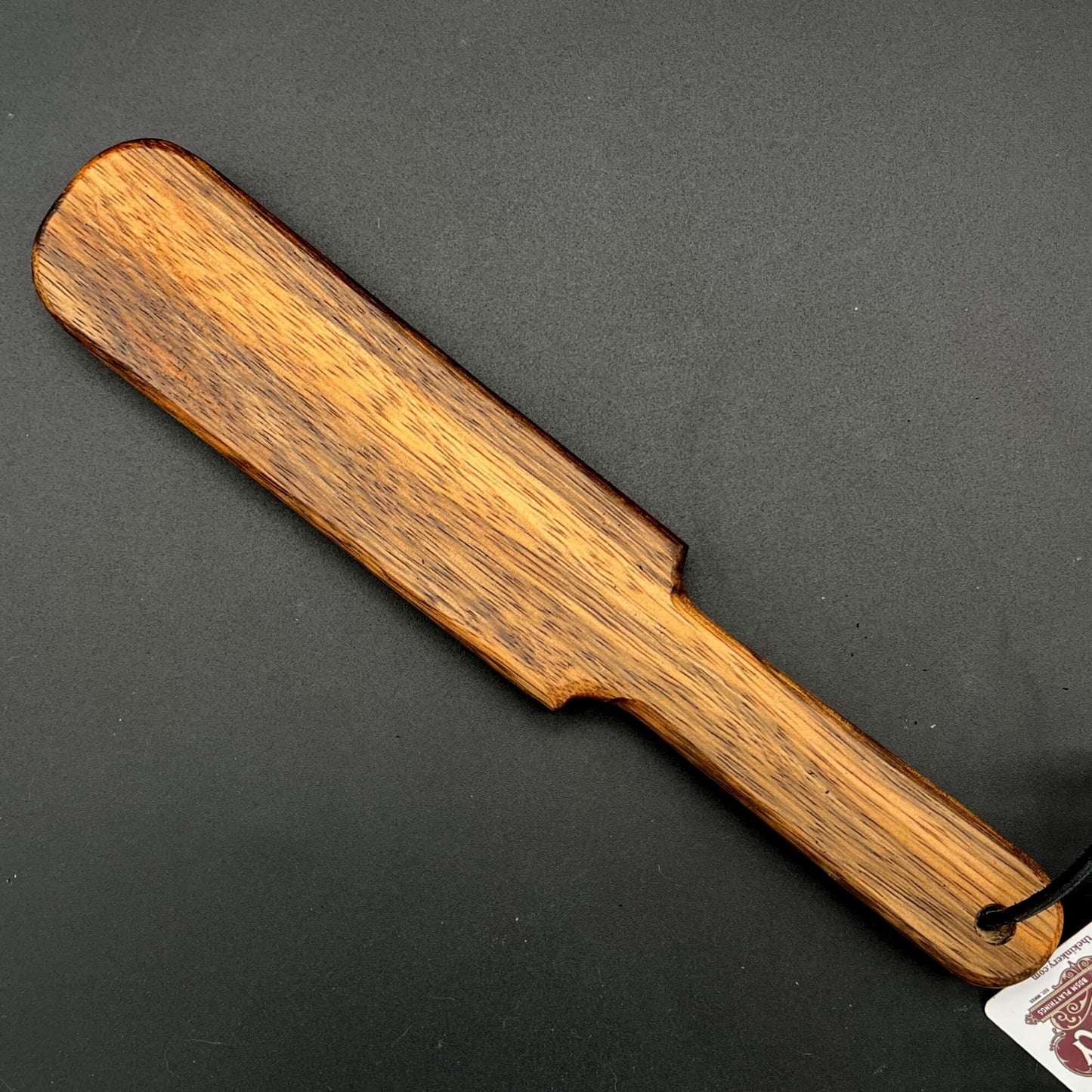 Pounder wooden paddle, simple paddle, finished in natural wax with rich brown wood grain, 12 inches long.