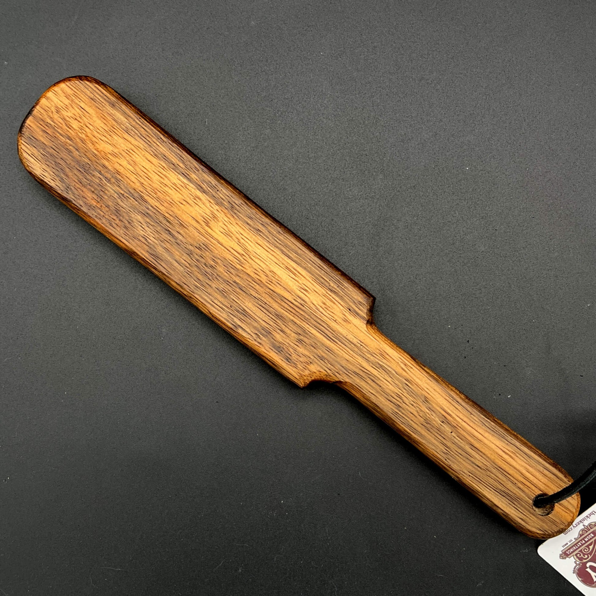 Pounder wooden paddle, simple paddle, finished in natural wax with rich brown wood grain, 12 inches long.