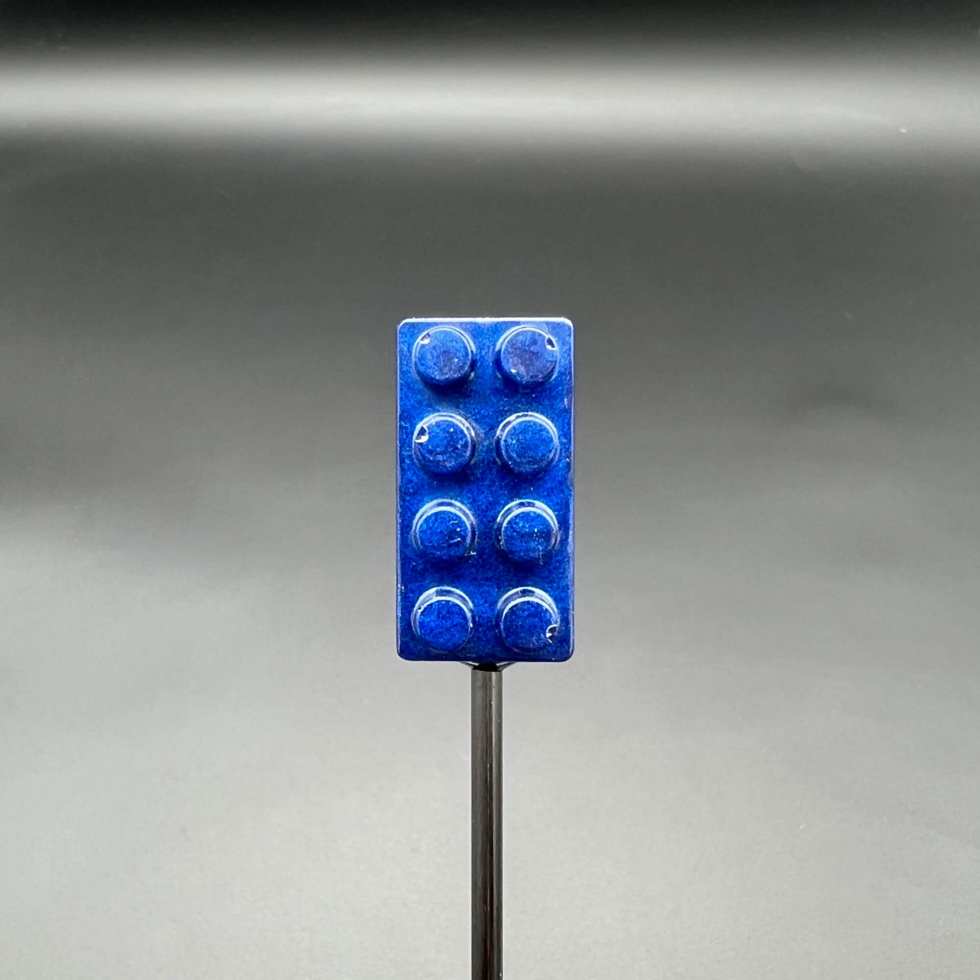 Building Brick Diabolical Sticks in blue color on a black background