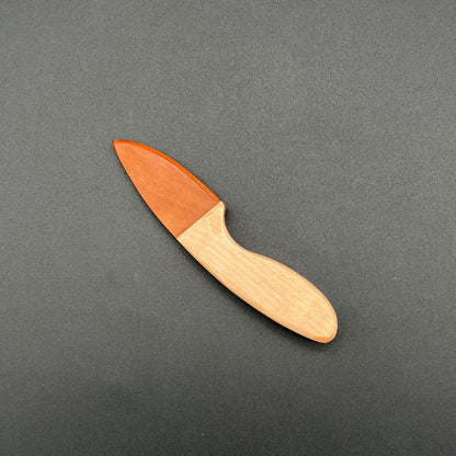 Skinner style wooden knife made with Etimoe wood for the blade (a red orange wood) and maple wood for the handle (a light brown/beige wood).