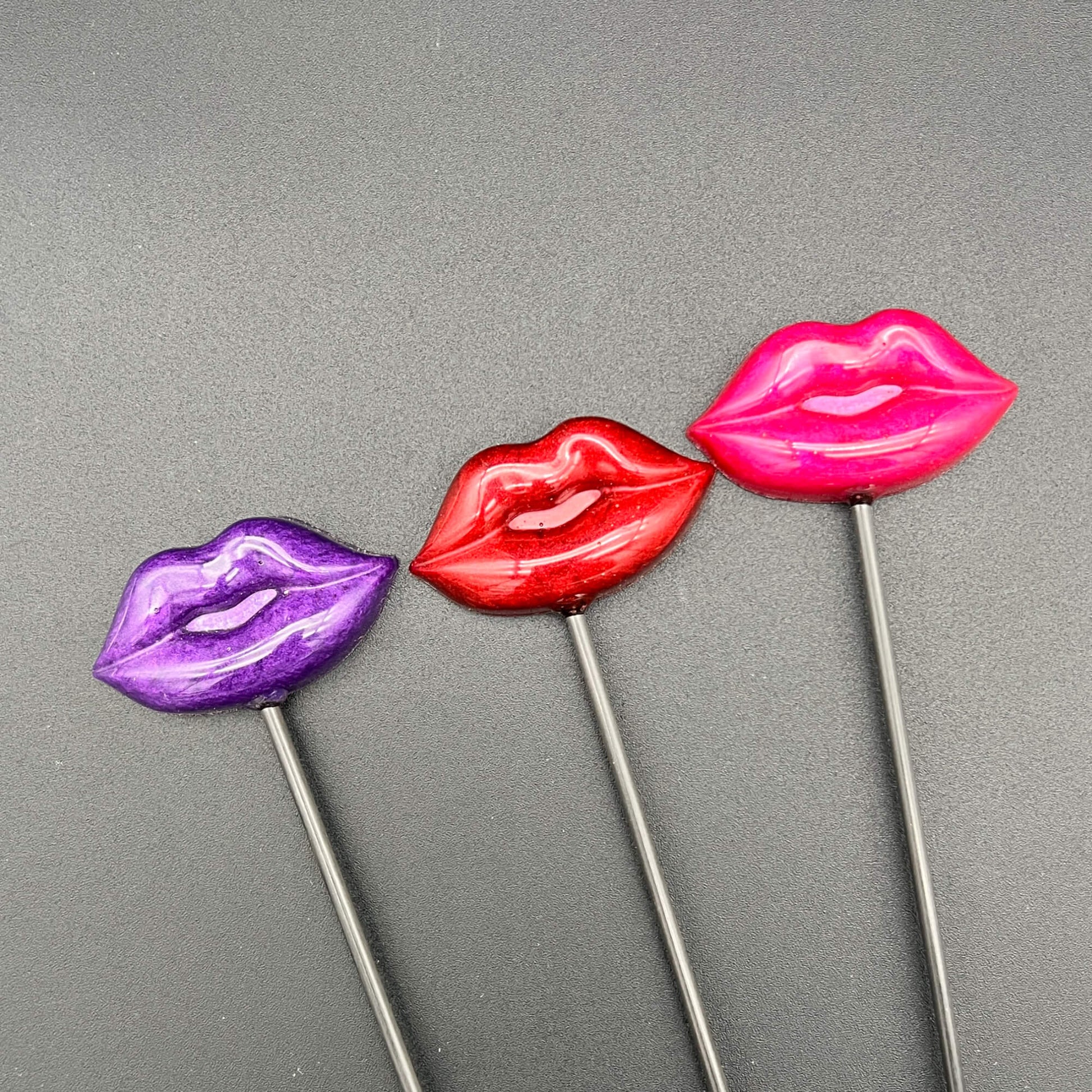 Lips Diabolical Sticks in purple, red, and pink colors showcasing playful resin lips on hand-turned sticks.