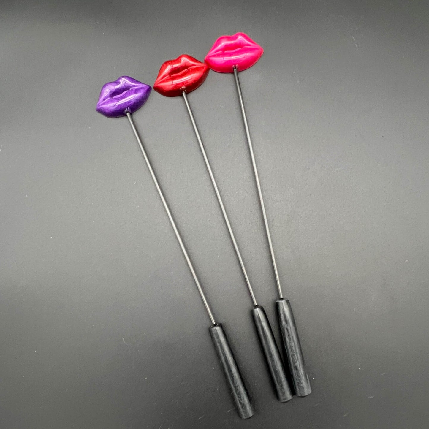 Lips Diabolical Sticks in purple, red, and pink with resin lips for a daring experience.