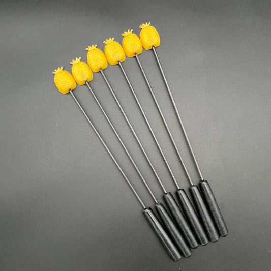 Set of Pineapple Diabolical Sticks featuring yellow pineapples on a black handle.