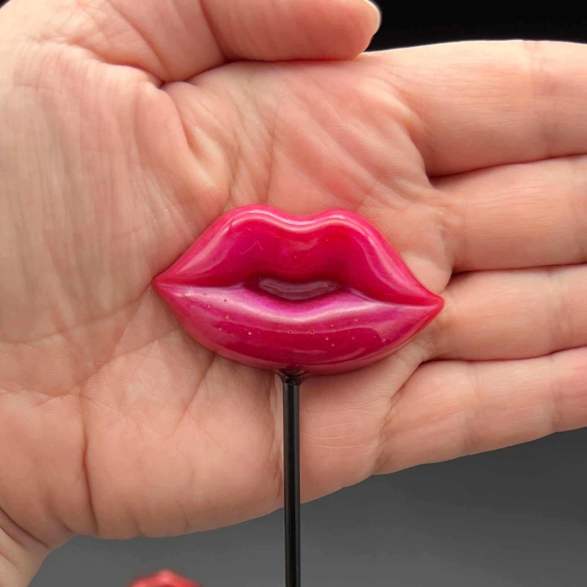 Lips Diabolical Sticks in pink, showcasing the hand-crafted resin lips design, perfect for playful pain.