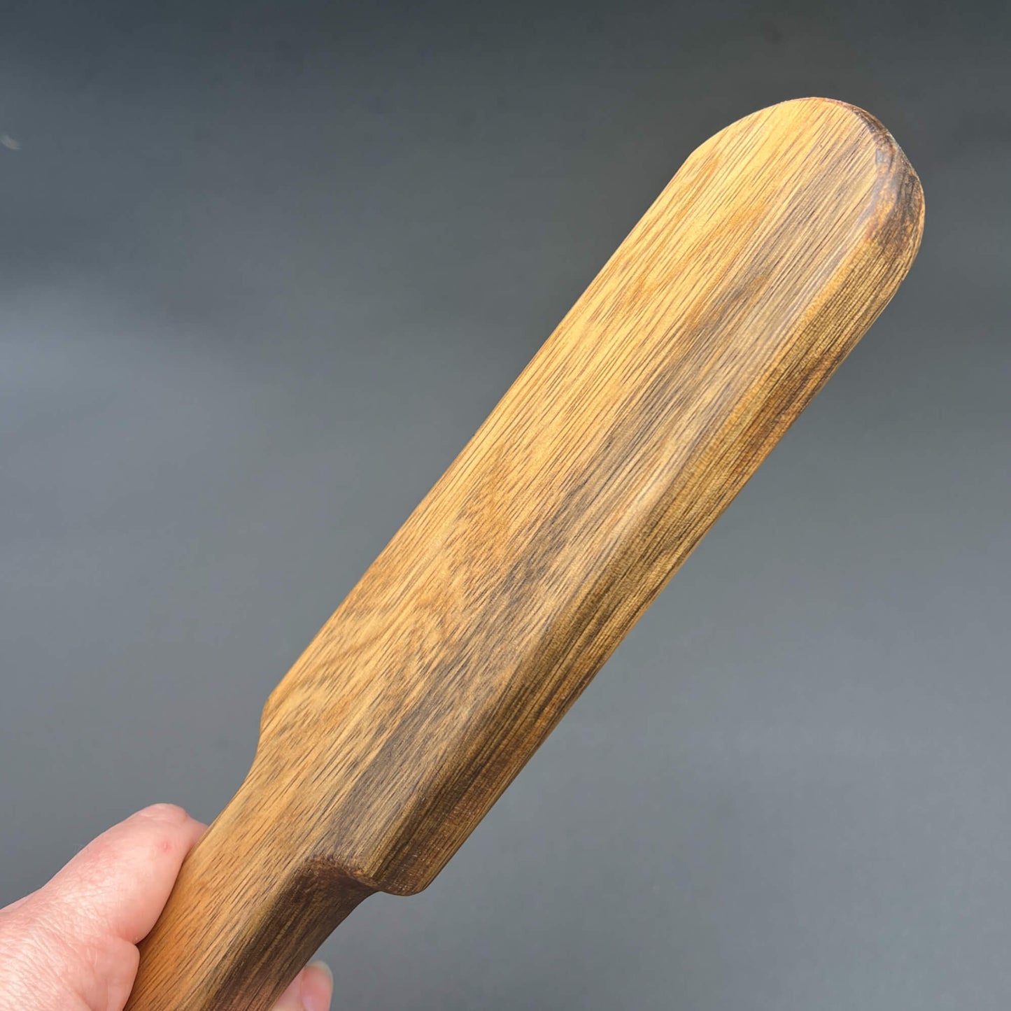 Wooden Pounder paddle, 12 inches long, showcasing natural grain finish and smooth edges.