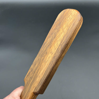 Pounder wooden paddle with a rich brown color, simple paddle design, showcasing natural wood grain finish.