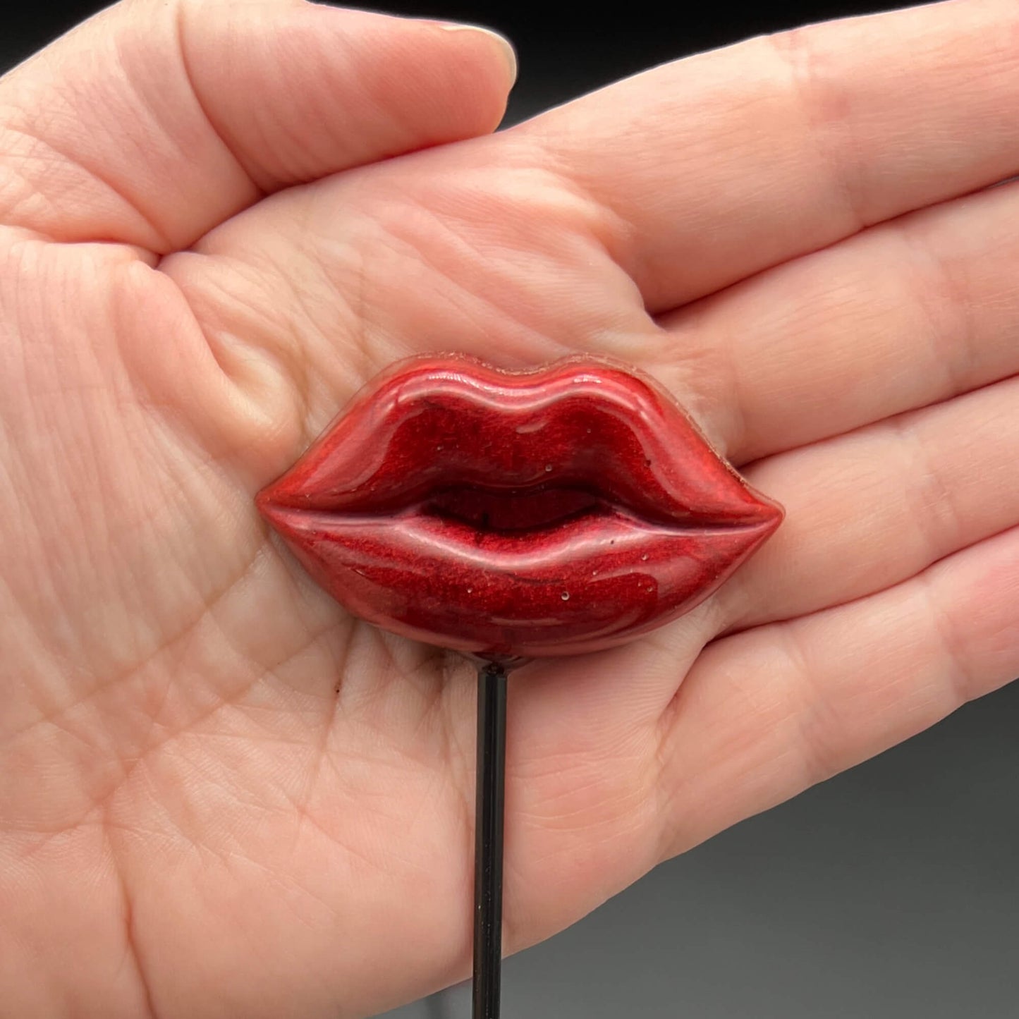 Lips Diabolical Sticks in red, showcasing hand-poured resin lips, perfect for adventurous play.