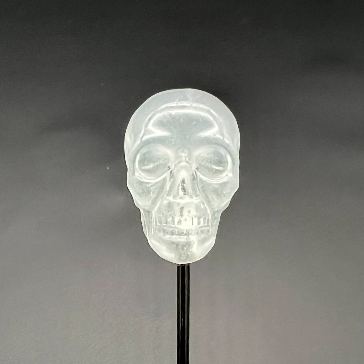 Close up of Skull Diabolical Stick of a transparent skull tip on black background