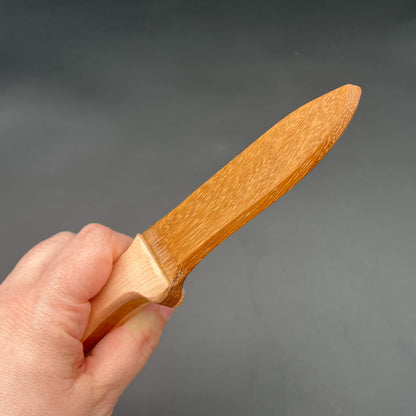 Spearpoint Wooden Knife held in hand, perfect for wax play and safe knife play scenarios.