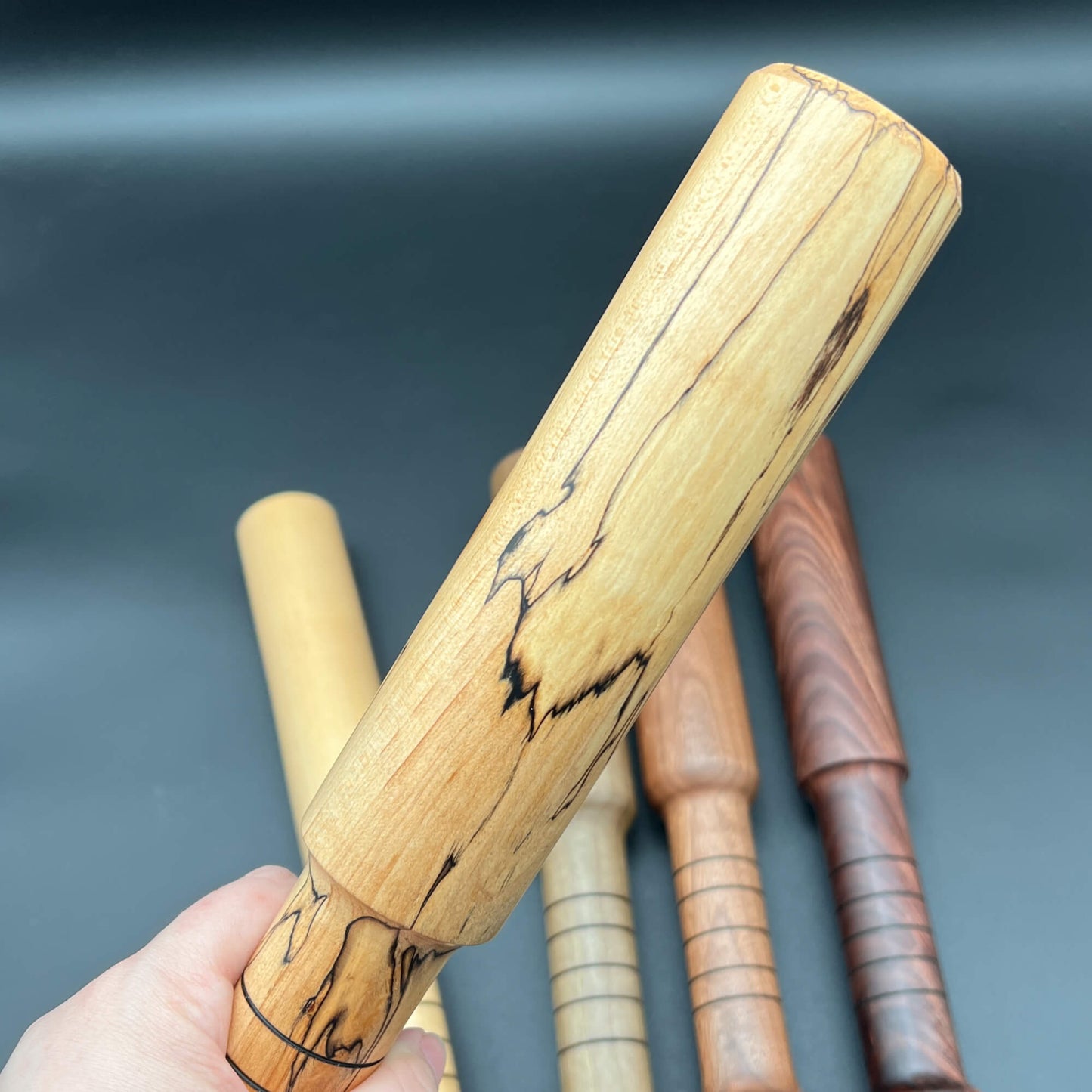 Thumper paddle for impact play, featuring a unique wooden design for thuddy sensations.