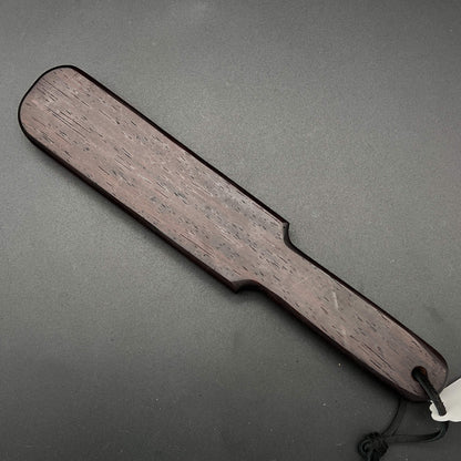 Pounder wooden paddle in rich dark brown color, 12 inches long, 2.25 inches wide, a simple paddle that packs a punch.