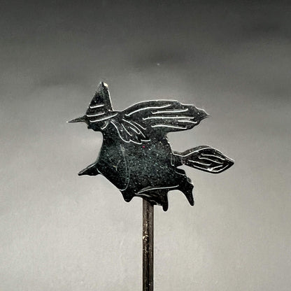 Close up of single witch resin tip; the witch is riding a broom
