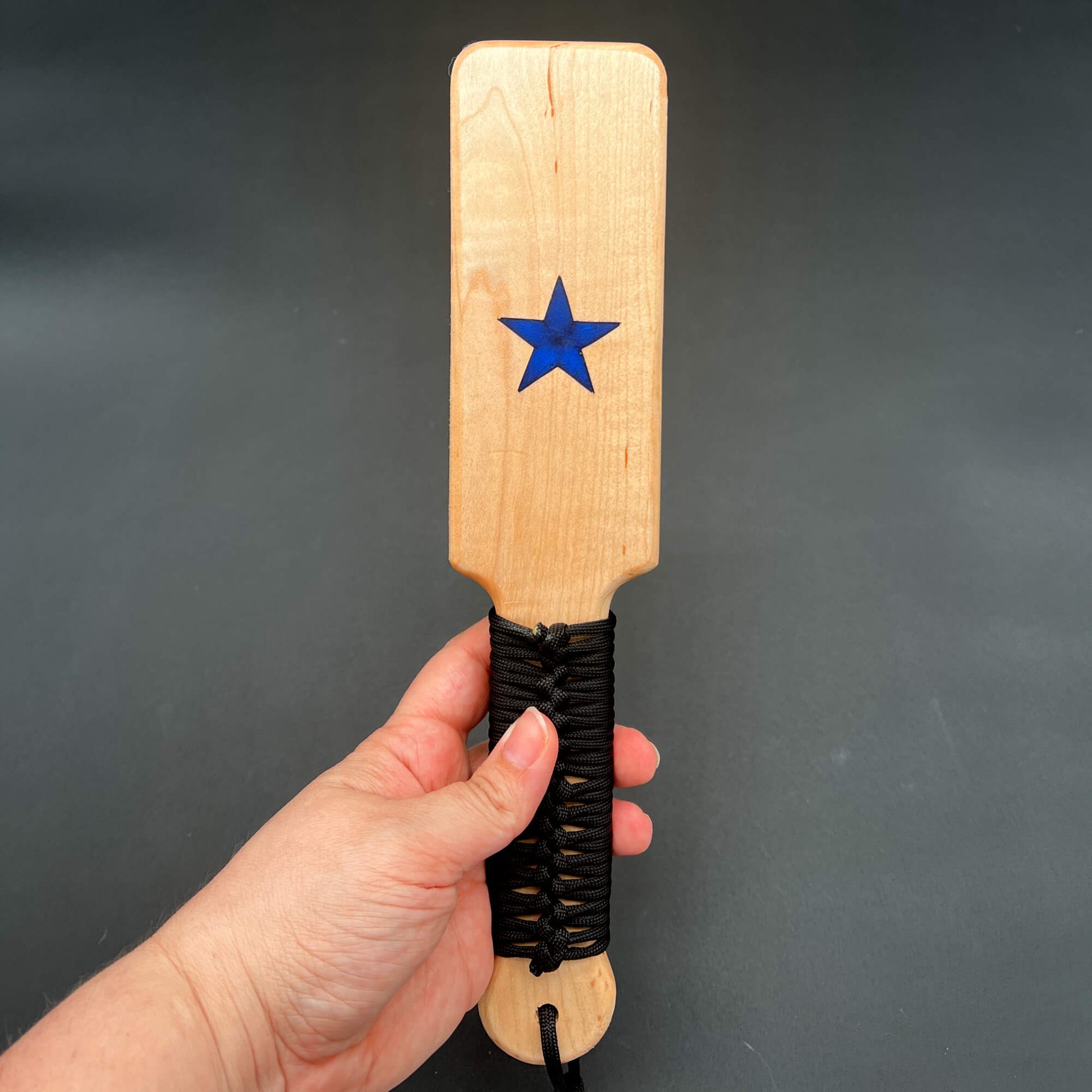 Small Resin Inlay Paddle with blue star design, smooth wood finish, and black paracord grip.