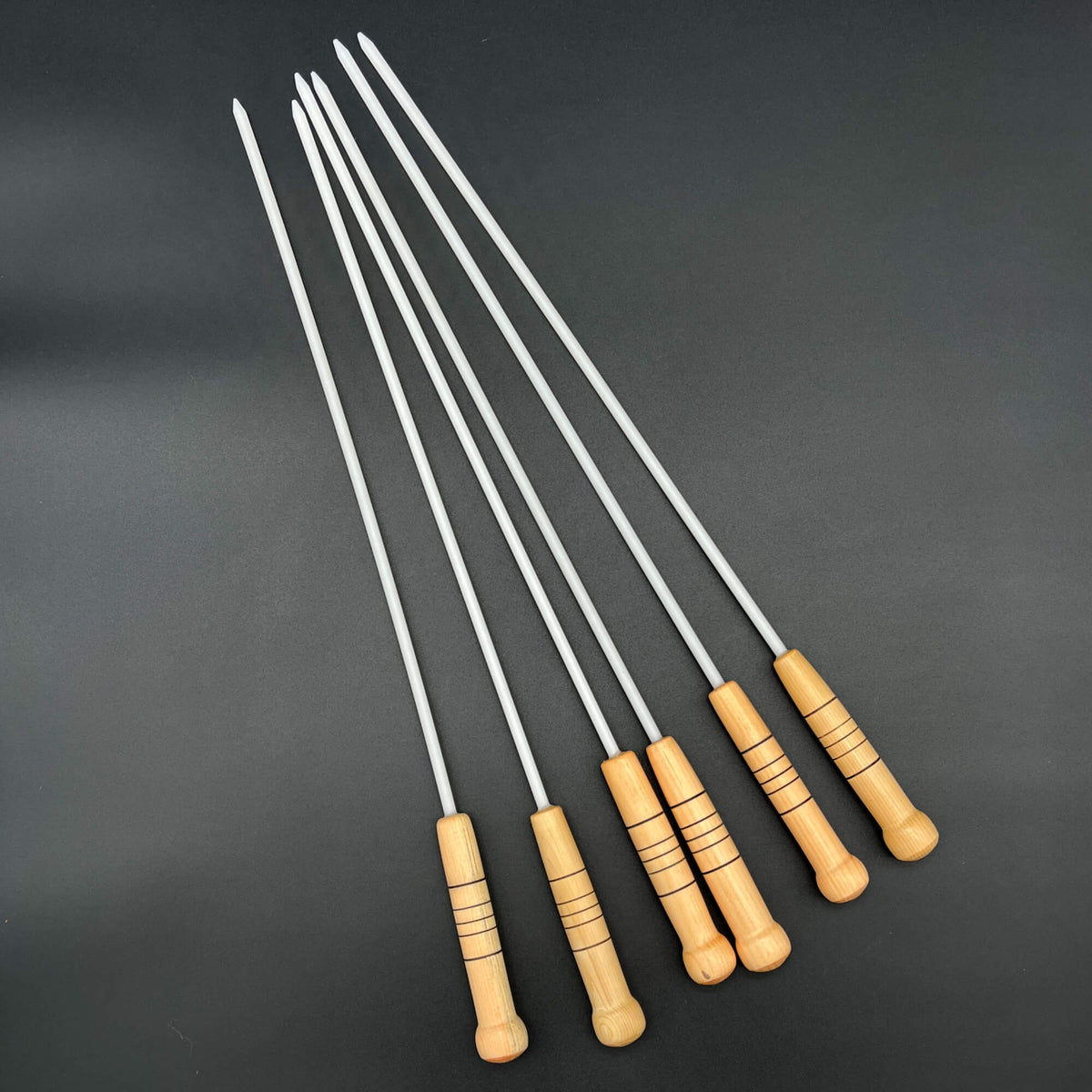 1/4 Inch Delrin Cane with wooden handle and flexible design, ideal for sting applications.