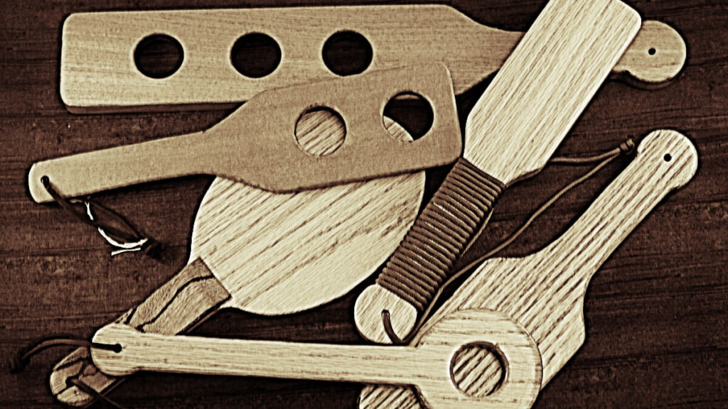 assortment of wooden paddles in sepia tones