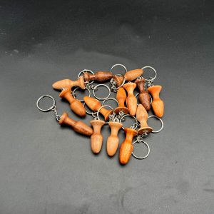 Mini butt plug keychains made in a variety of woods