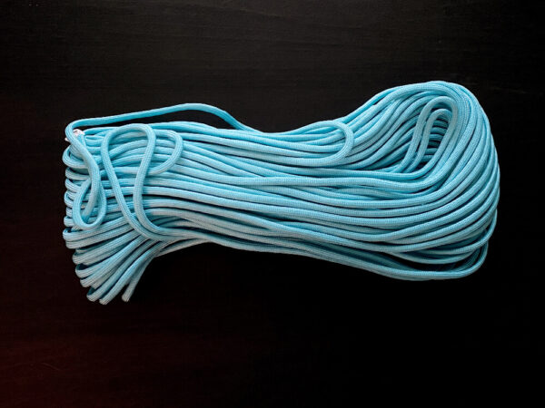 Turquoise paracord on dark brown background