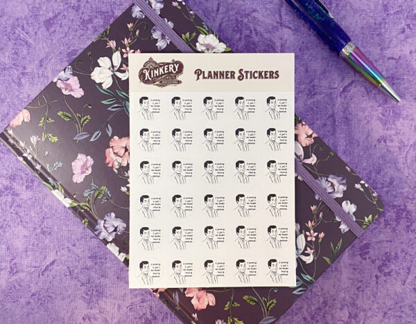 sheet of one handed round of applause planner stickers on purple floral planner next to turquoise pen on purple background