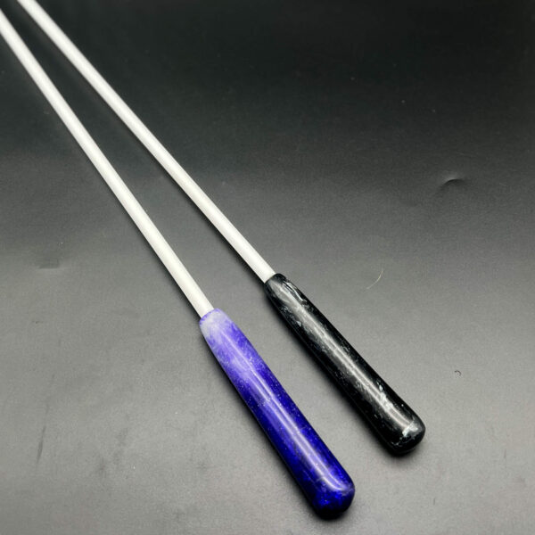 Two examples of 3/8 inch Delrin canes with resin handles. On the left, purple and glow-in-the-dark resin. On the right, silver and black resin.
