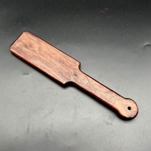 small wooden paddle made from black walnut