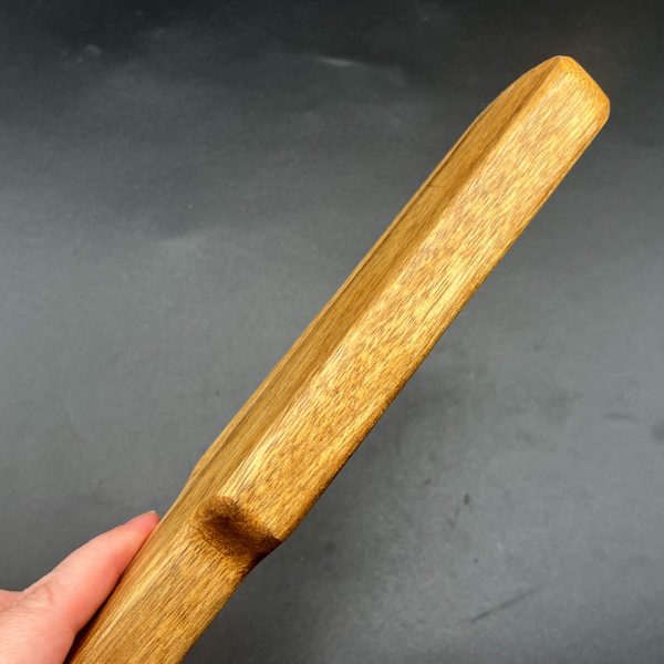 Side view of the Black Limba Pounder to show how thick this wooden paddle is - just under an inch thick
