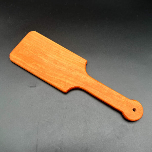 wooden paddle made to look like large hairbrush made of cherry