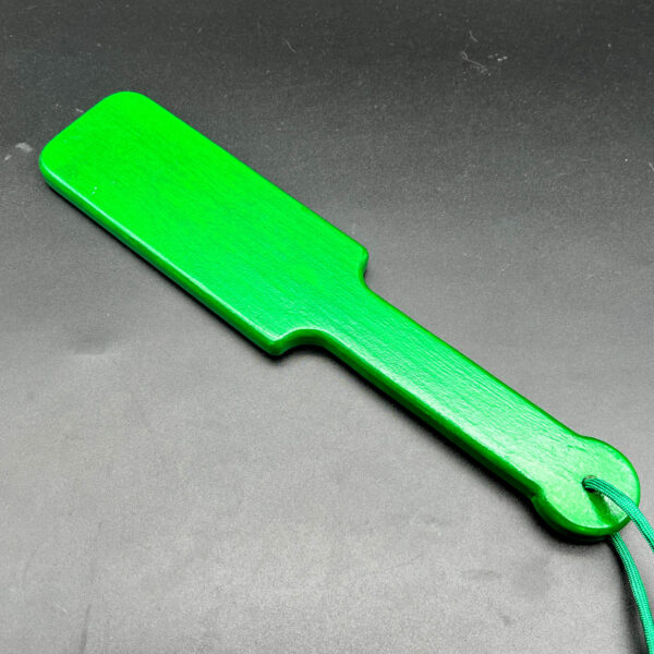 Small wooden paddle stained green