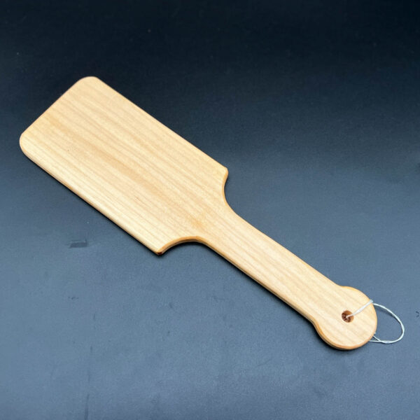 wooden paddle made to resemble large hairbrush in maple