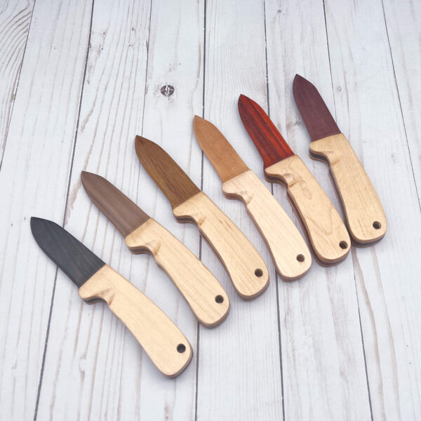 Array of wooden knives with a variety of woods for the blades: Wenge, Black Walnut, African Mahogany, Cherry, Paduak, and Purpleheart