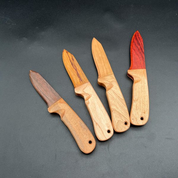 Four wooden knives. Left to right: Black Walnut, Honey Locust, Cherry, Bloodwood