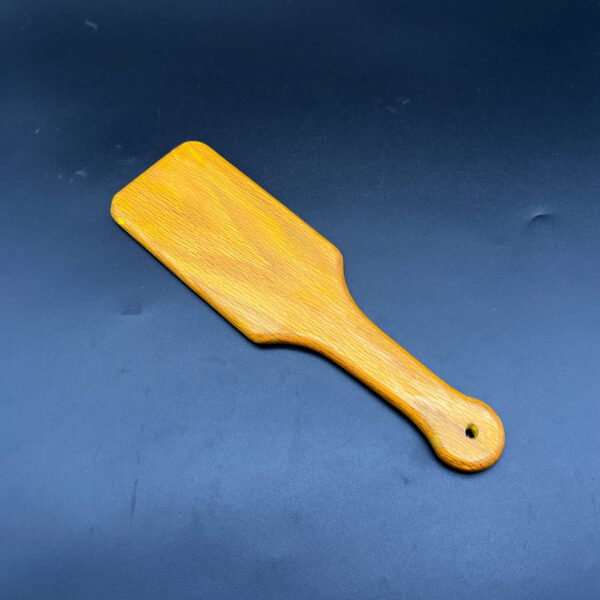 hairbrush style wooden paddle stained yellow using Unicorn Spit