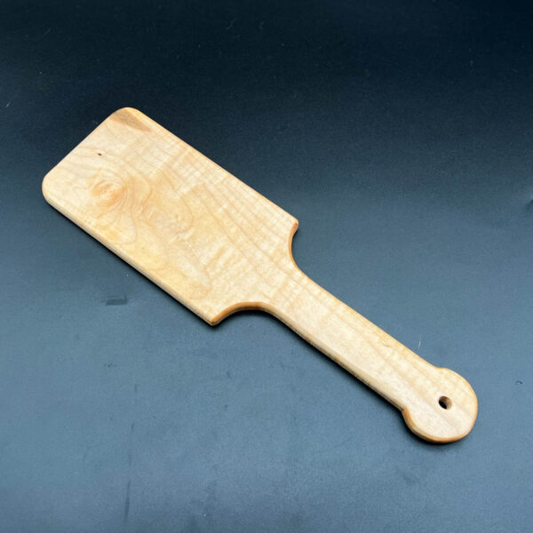 wooden paddle that looks like large hairbrush made in curly maple