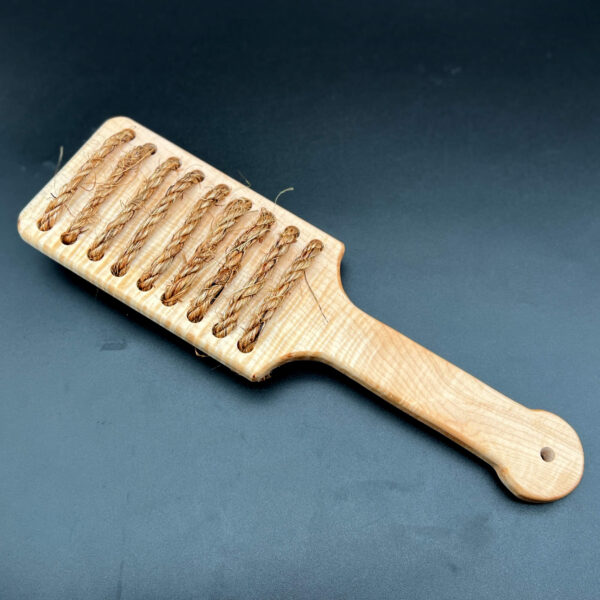 Rough Rider paddle made in Curly Maple - a light, almost white wood with a swirled, shiny grain pattern