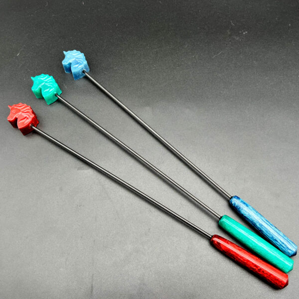Three unicorn diabolical sticks, left to right: red, teal, and blue