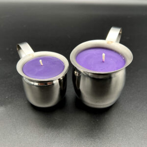 Two purple soy wax play candles in silver containers. The small (3oz) is on the left and the large (5oz) is on the right. The containers are silver creamer pots with handles.