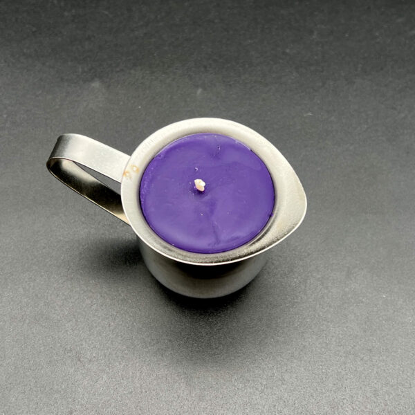 Overhead view of single small (3oz) purple soy wax play candle in silver container with handle
