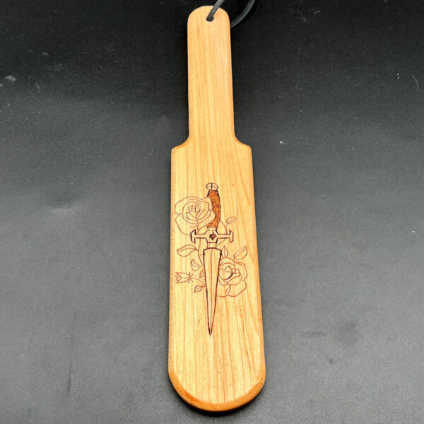 Pounder style paddle made of maple with rose and sword wood burned into center of paddle