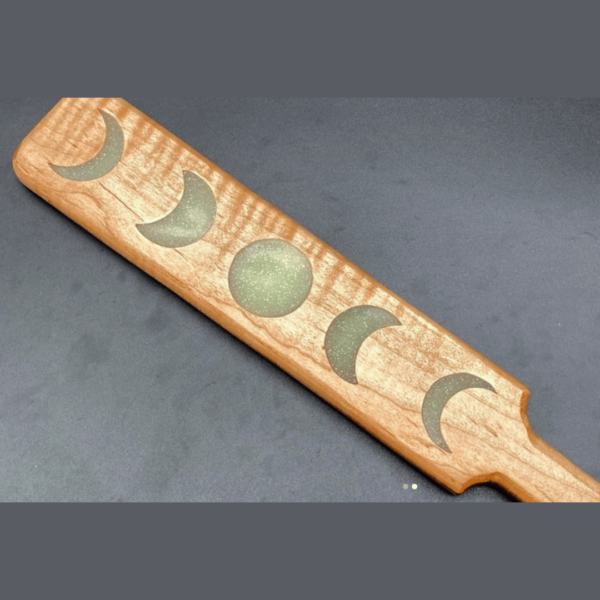 Close up of resin moon phases in maple paddle