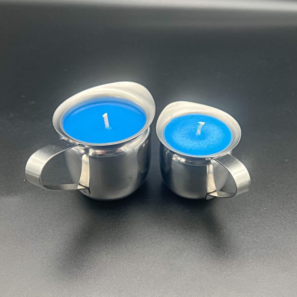 3 ounce (right) and 5 ounce (left) stainless steel containers with handles and pour spouts filled with blue soy wax used in wax play